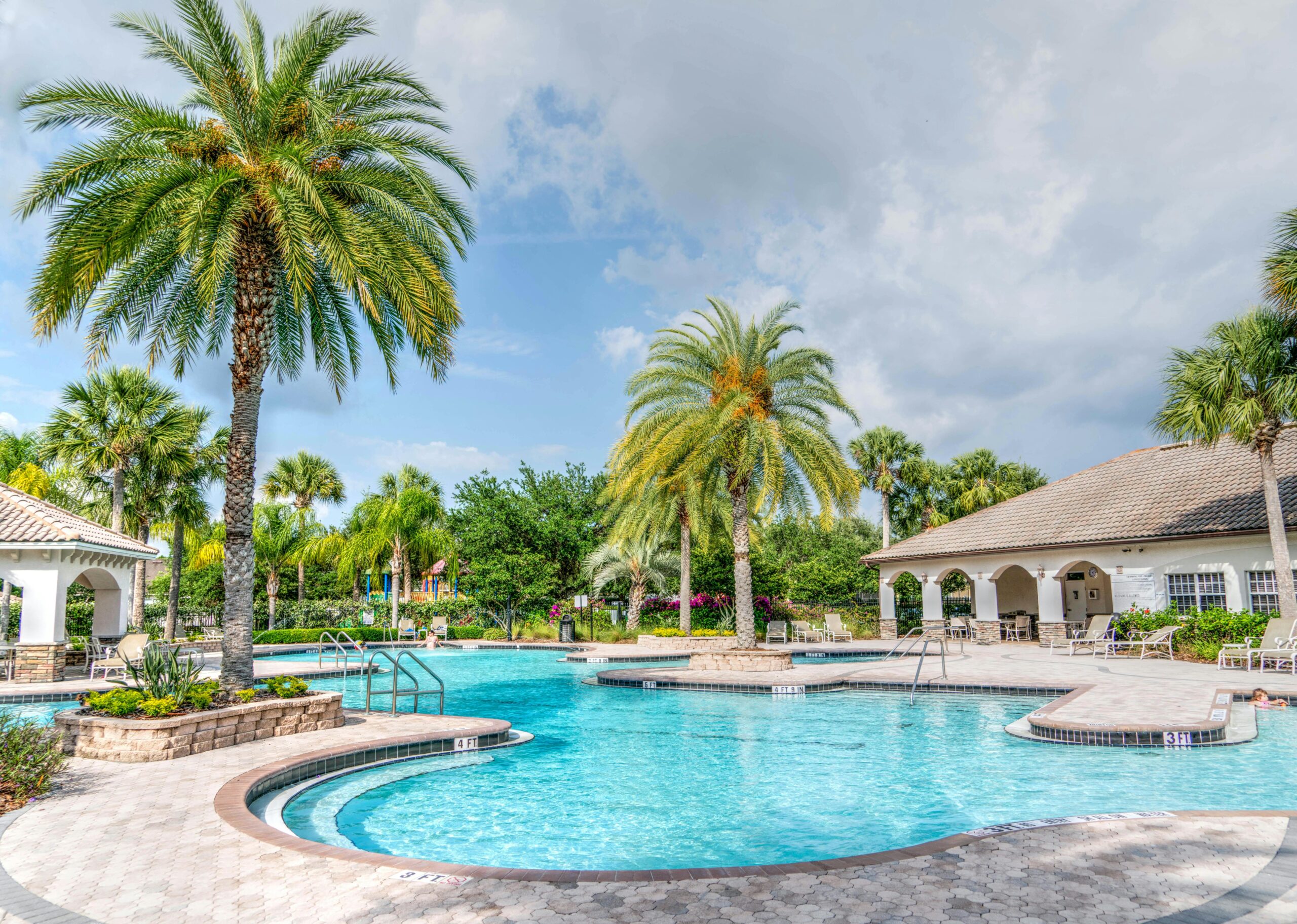 Idyllic tropical resort featuring palm trees, tranquil poolside setting, and relaxing vacation vibes.